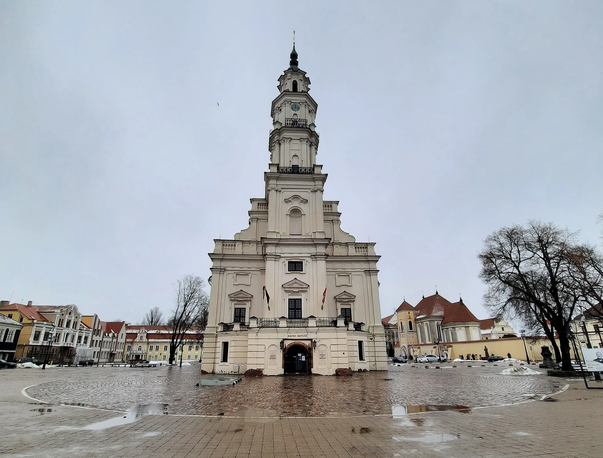 White tower and façade of Kaunas Town Hall overlooking its cobbled square