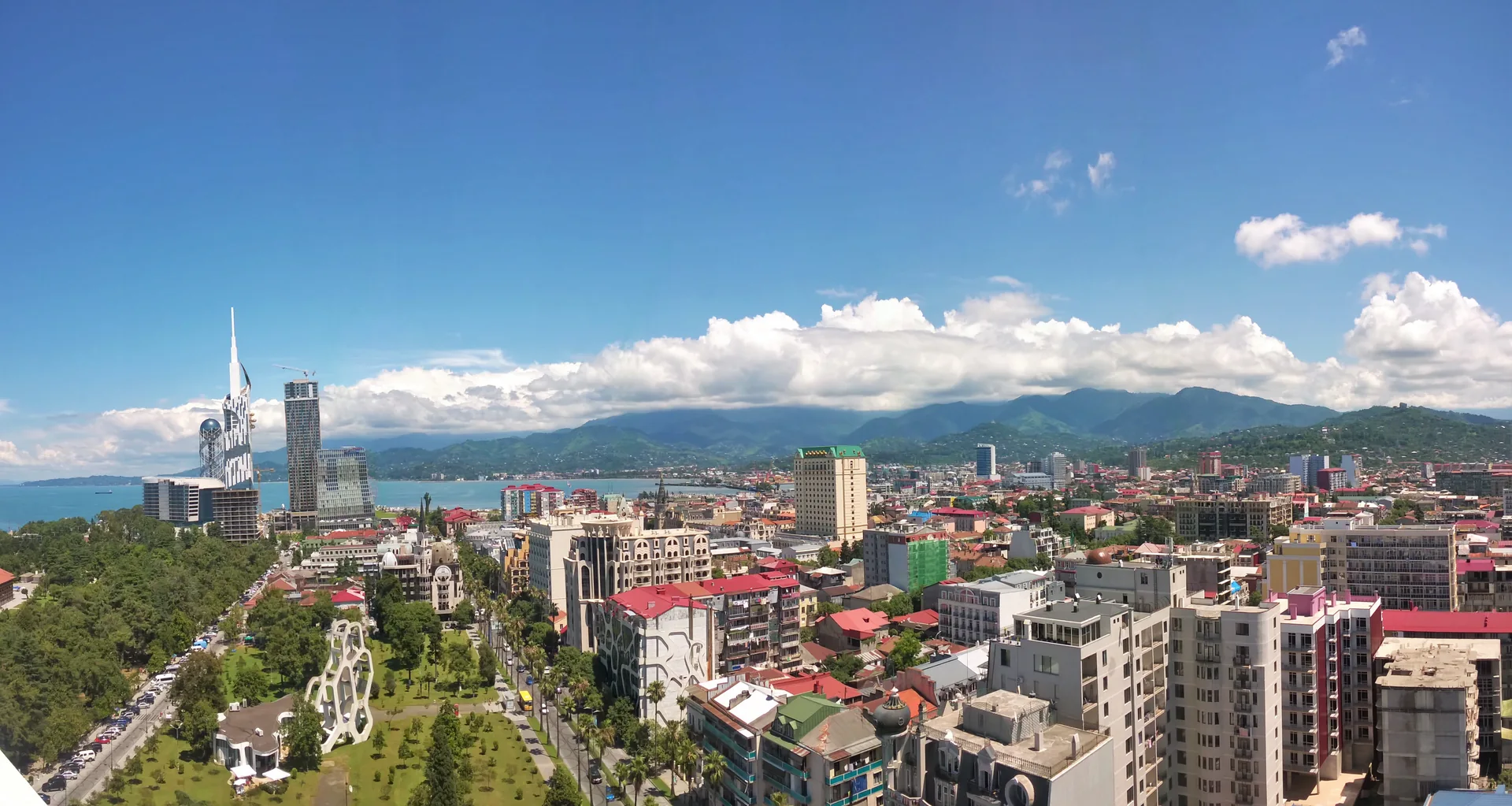Batumi’s central park, coastal cityscape and landmark towers with mountains behind