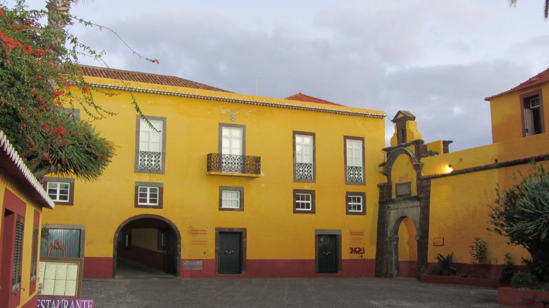 The yellow courtyard and entrance of São Tiago fortress in Funchal