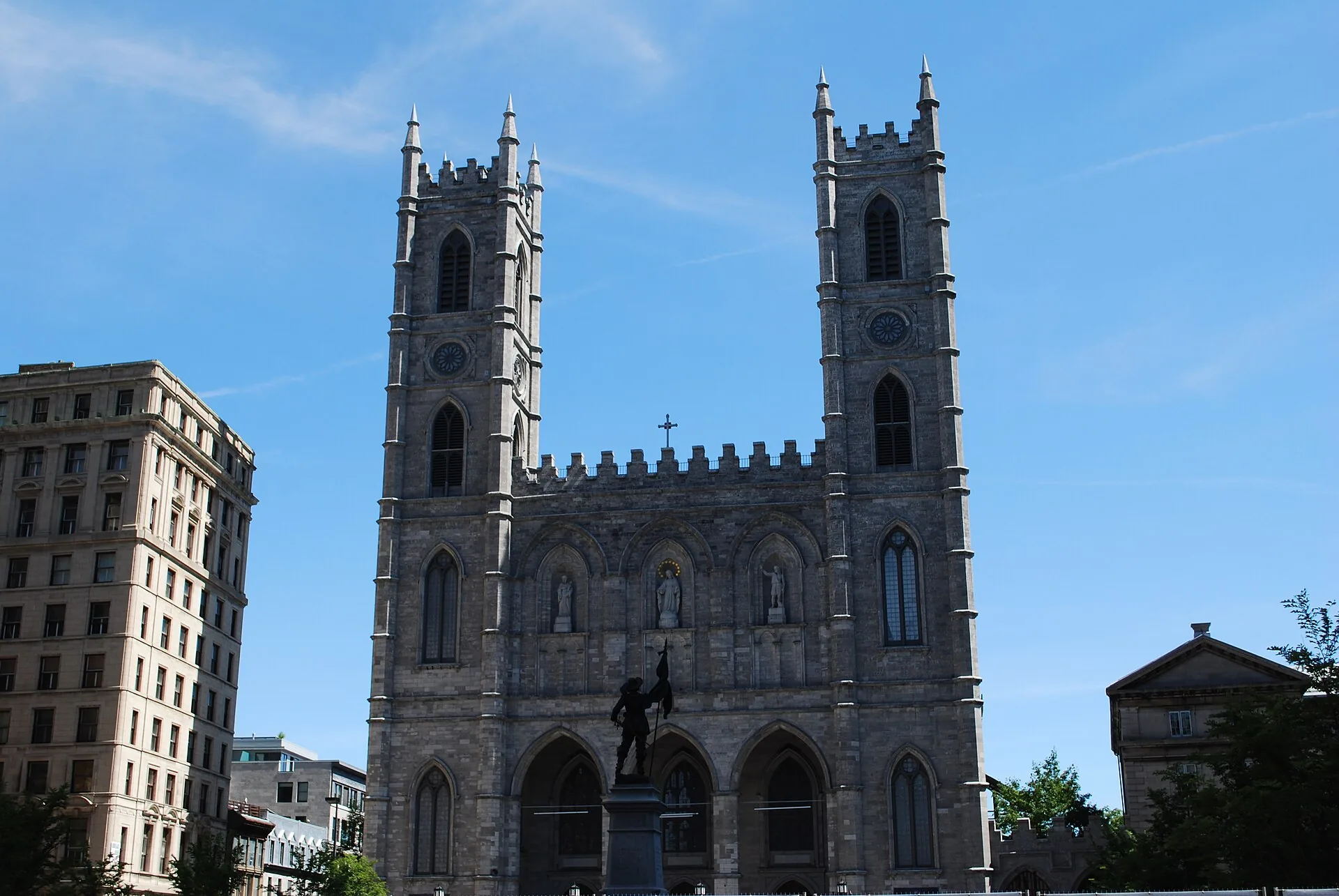 The twin towers and stone façade of Notre-Dame Basilica in Old Montreal