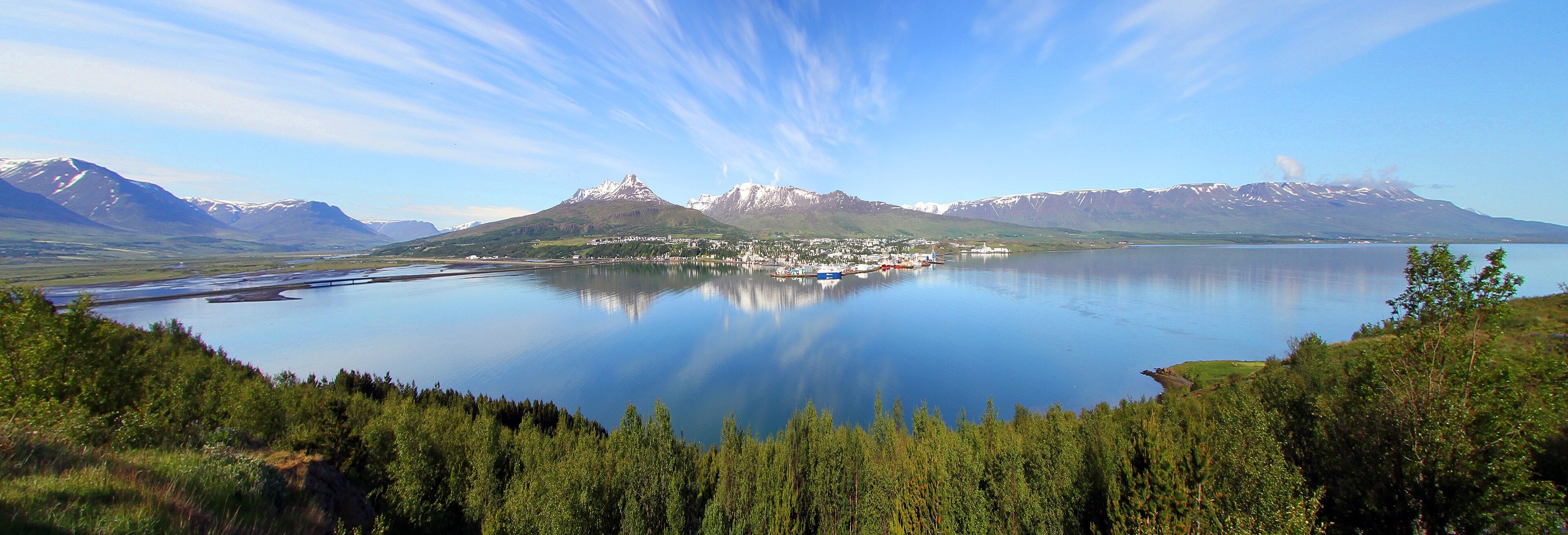 Akureyri and its harbour on Eyjafjörður, backed by mountains reflected in the fjord