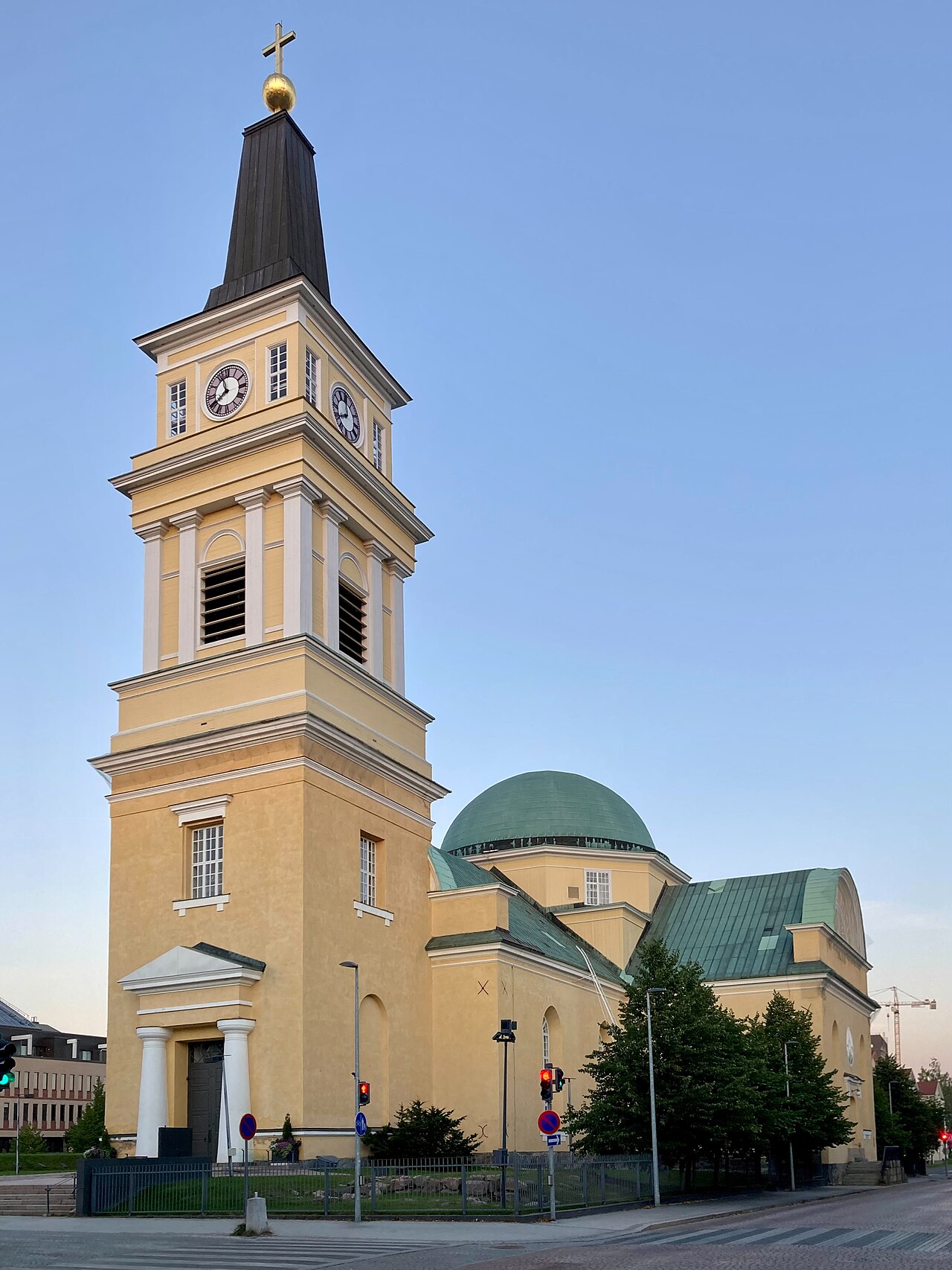 Oulu Cathedral’s yellow clock tower, gilded cross and green dome