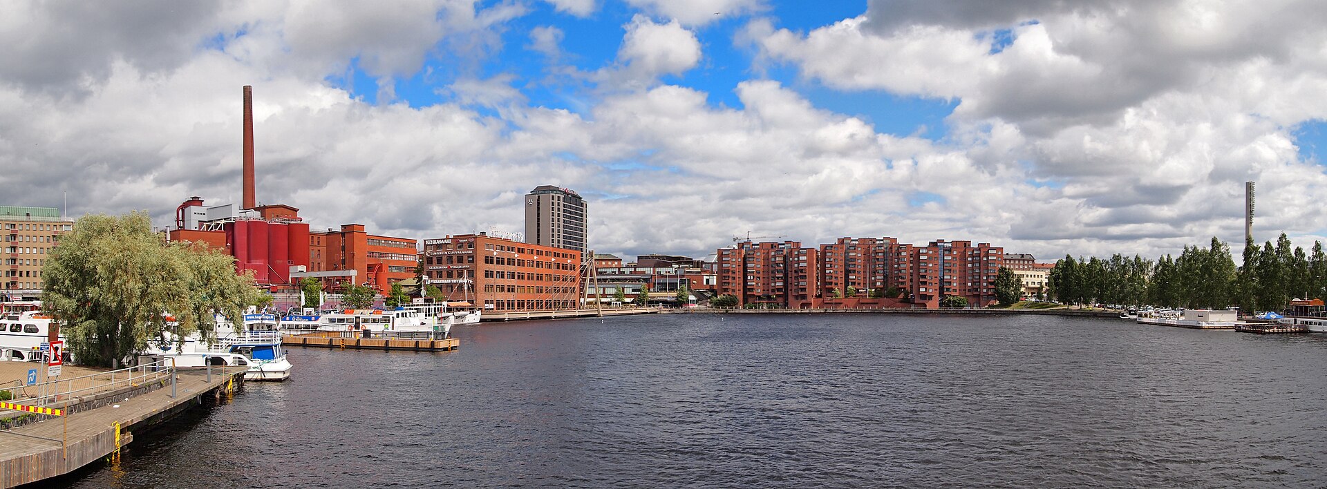Tampere’s red-brick waterfront, boats and chimney viewed from Laukonsilta bridge