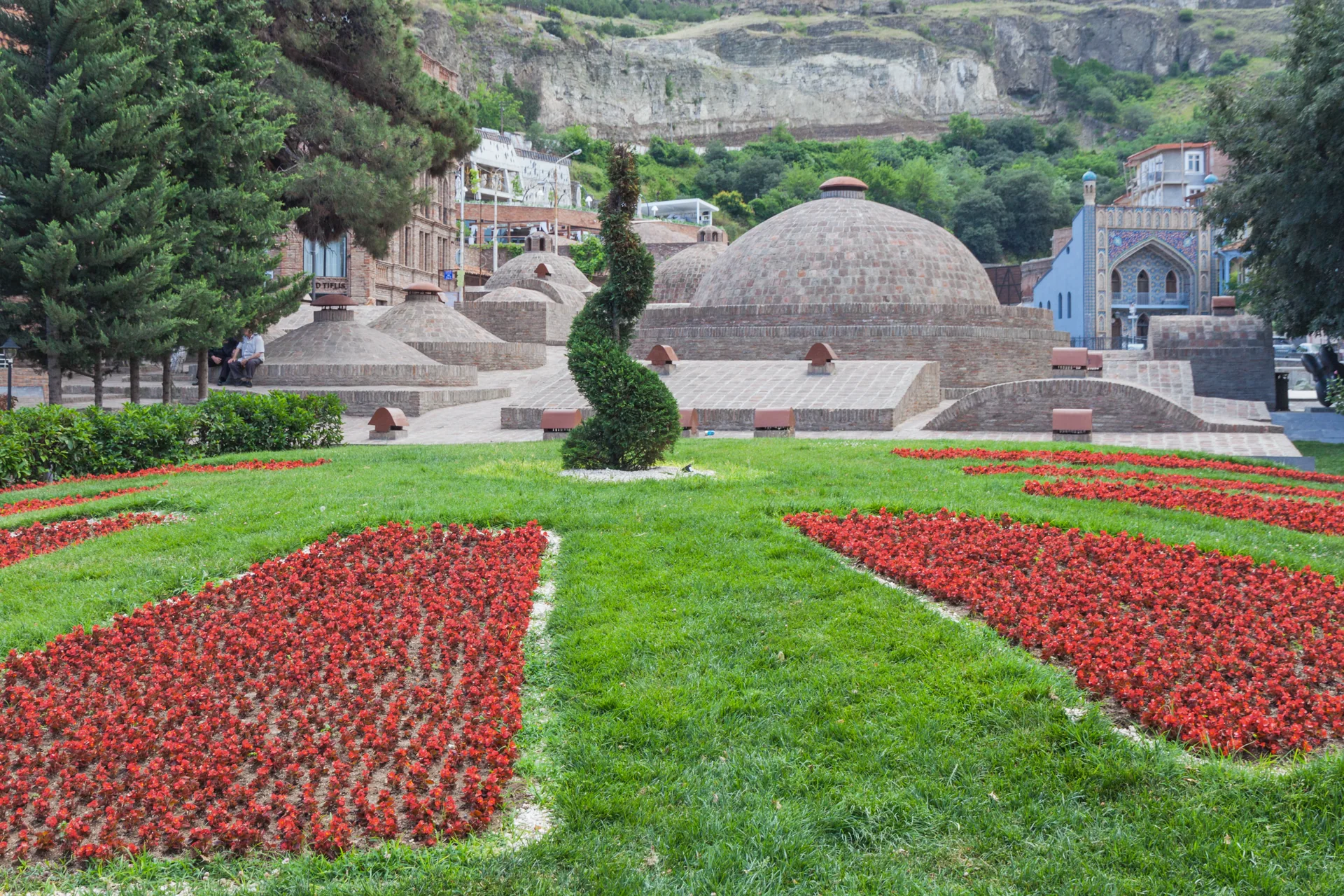 Brick-domed sulphur baths and the blue bathhouse facade in Tbilisi’s Abanotubani district