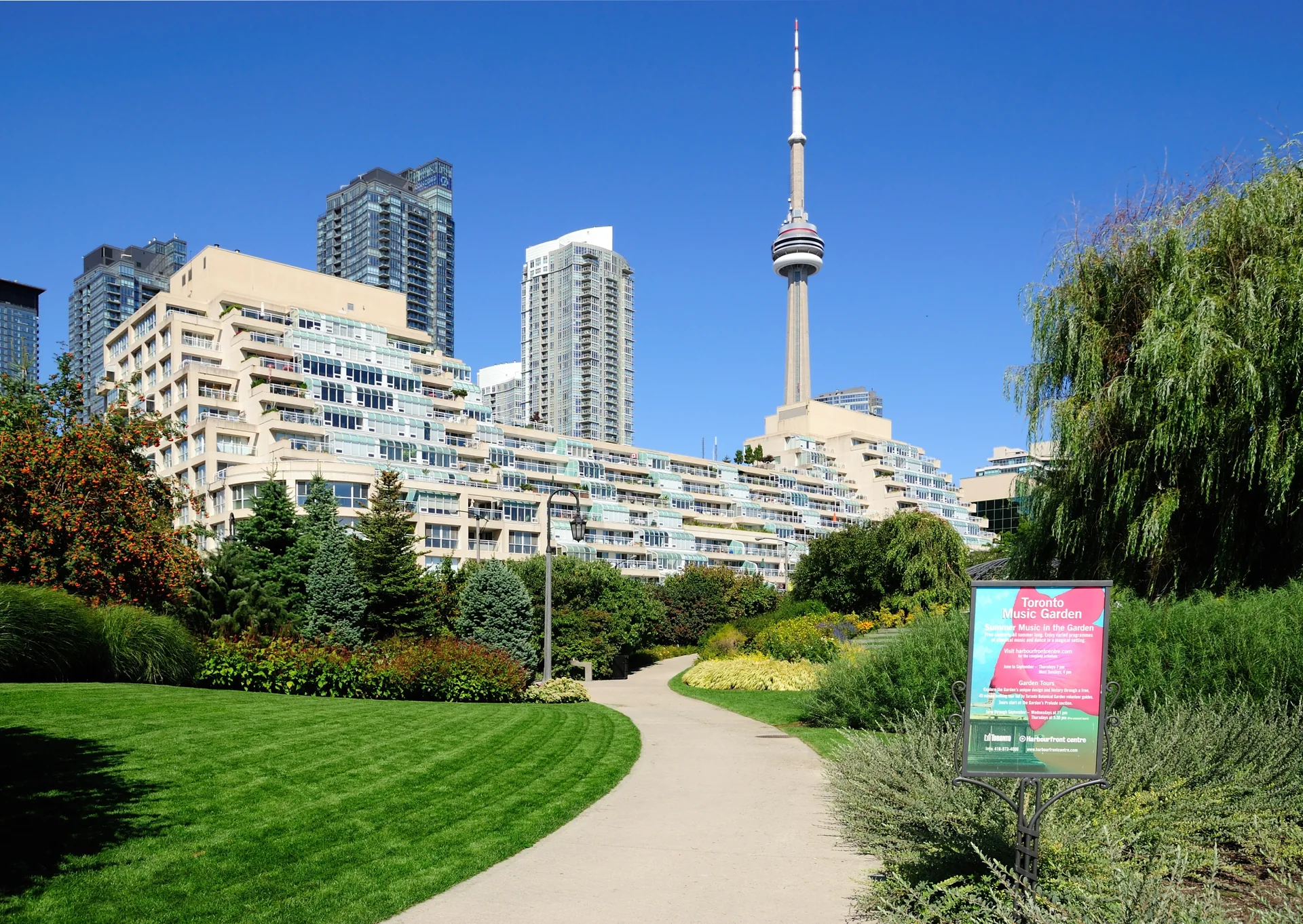 The Toronto Music Garden with its garden path, waterfront buildings and CN Tower