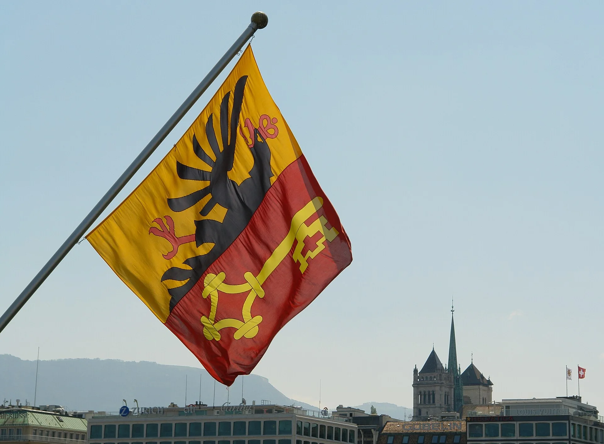 Saint-Pierre Cathedral and a Geneva flag in the old town.