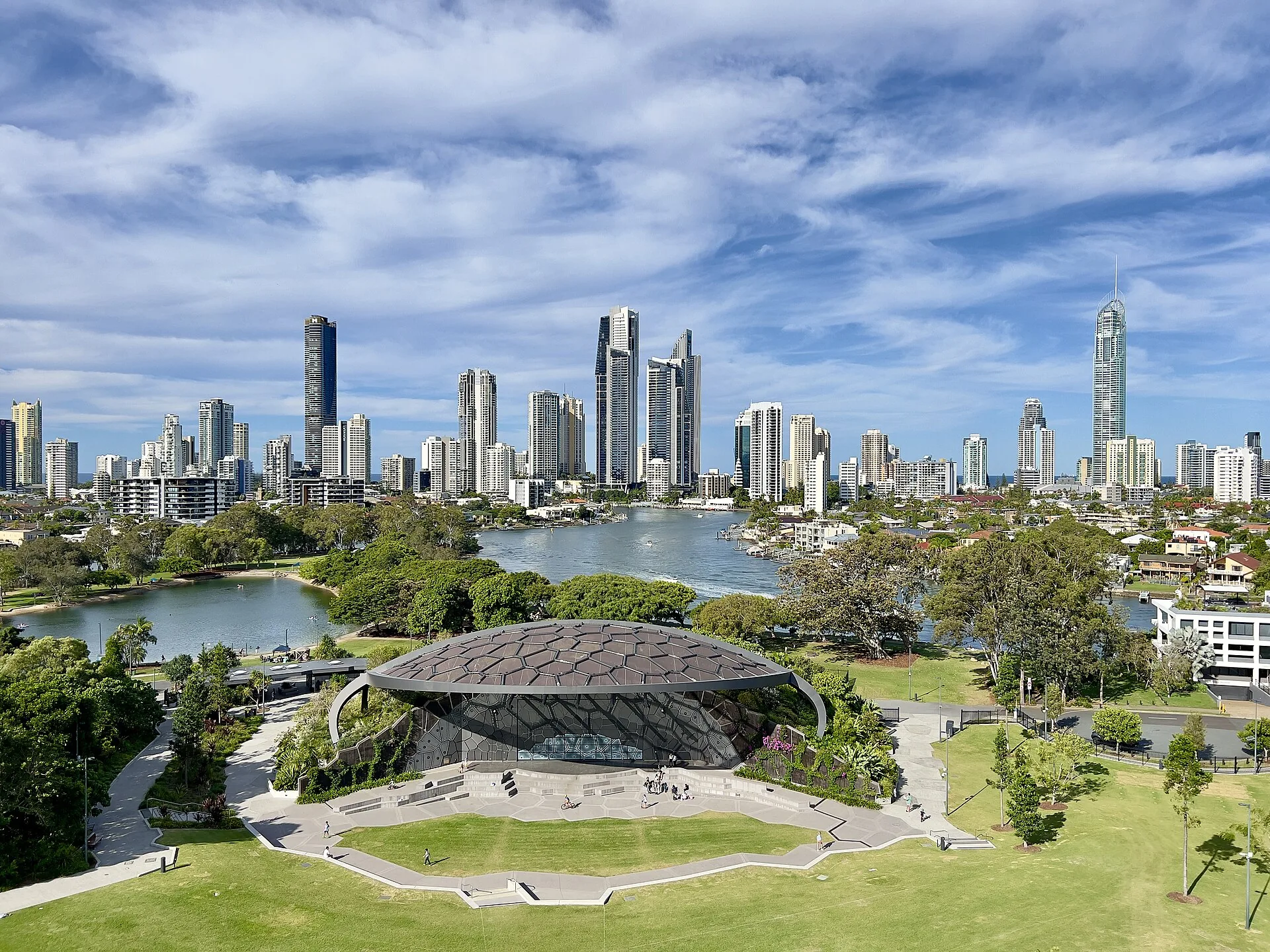 Surfers Paradise skyline and Q1 beyond the HOTA outdoor stage and Evandale Lake on the Gold Coast.