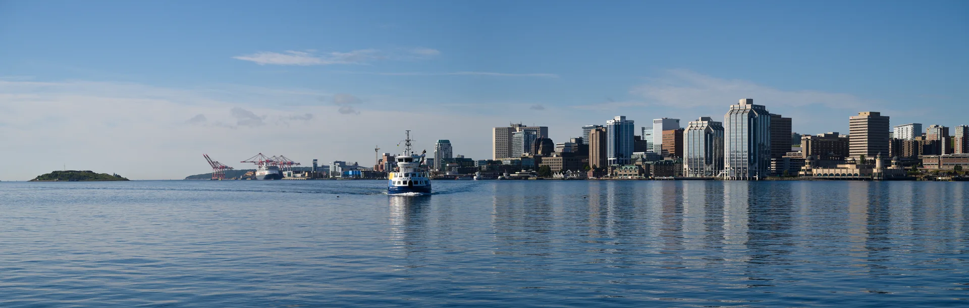 Halifax’s waterfront skyline and a passenger ferry viewed across the harbour.