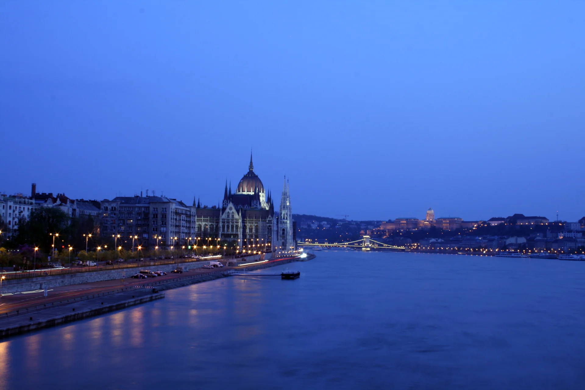 Hungarian Parliament illuminated beside the Danube in Budapest at blue hour