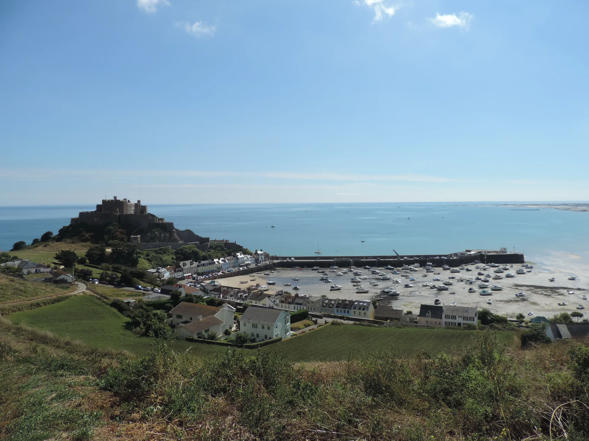 Mont Orgueil Castle above Gorey village and its harbour at low tide, Jersey