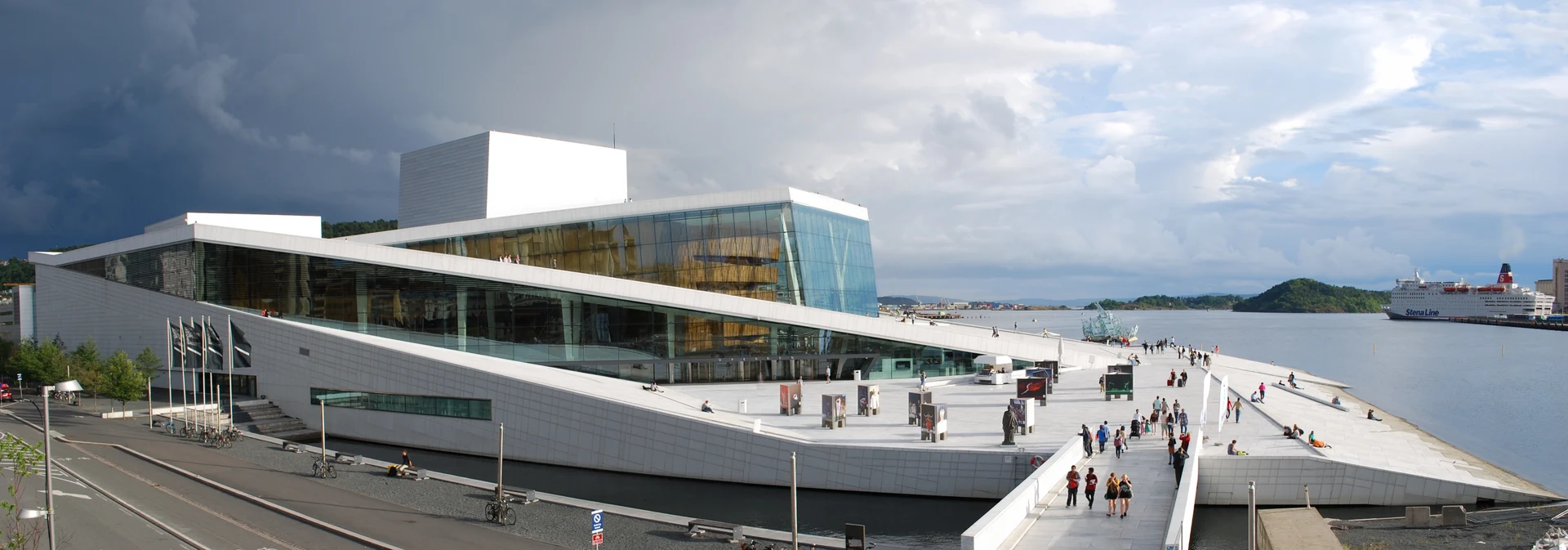 Oslo Opera House and its sloping white roof beside the Oslofjord in Bjørvika