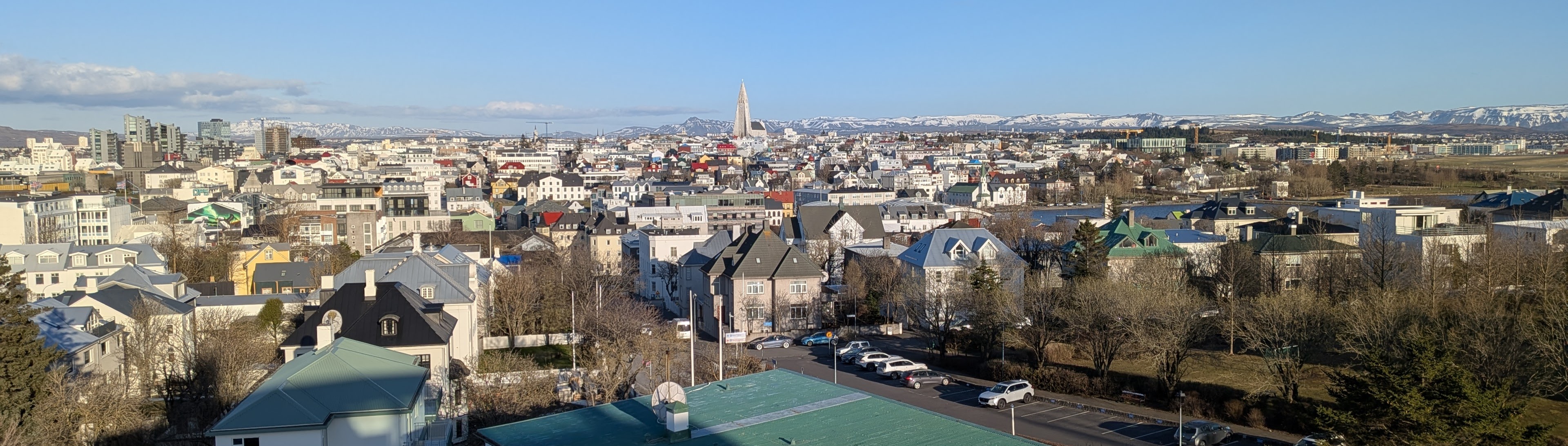 Reykjavík skyline with Hallgrímskirkja above colourful houses and distant mountains