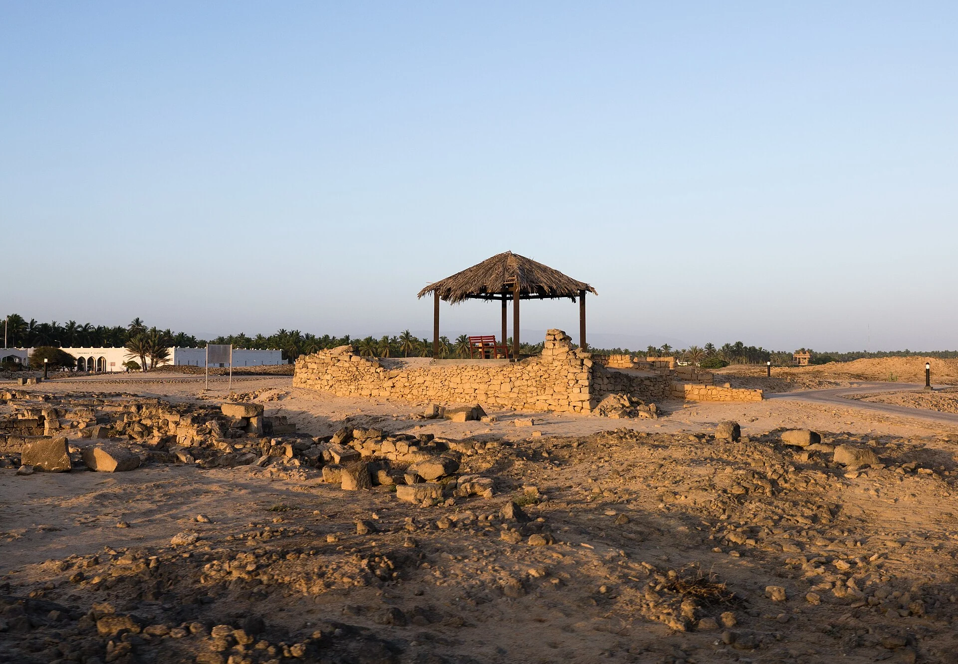 Stone ruins at Al Baleed Archaeological Park in Salalah in warm late-afternoon light