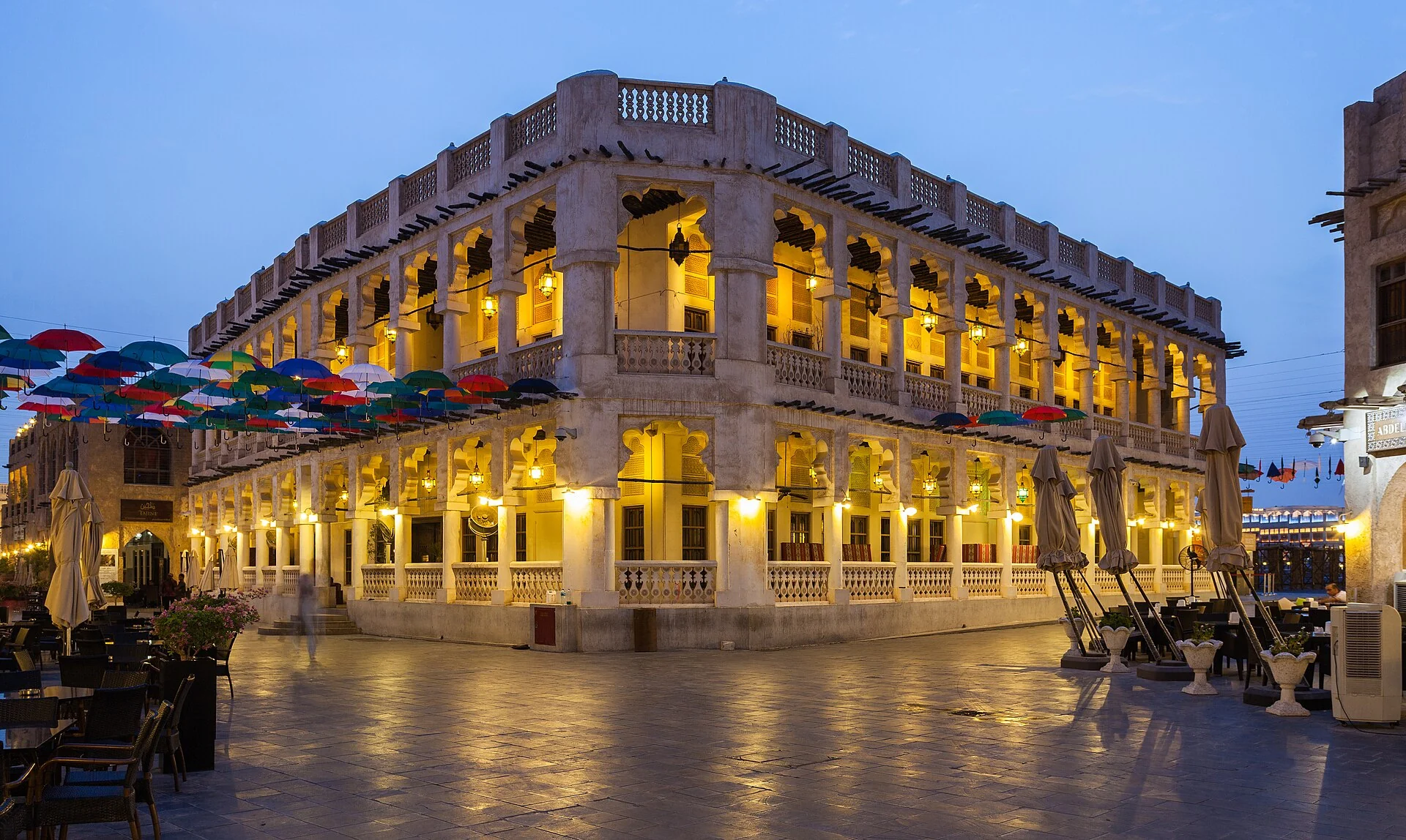 Warmly lit arcades and traditional buildings at Souq Waqif in Doha at dusk