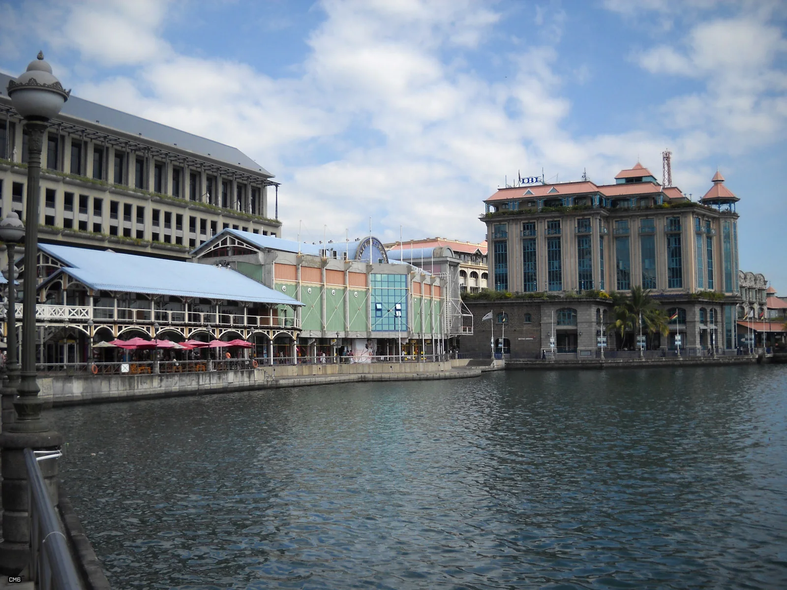 Historic Caudan Waterfront buildings reflected in the harbour at Port Louis